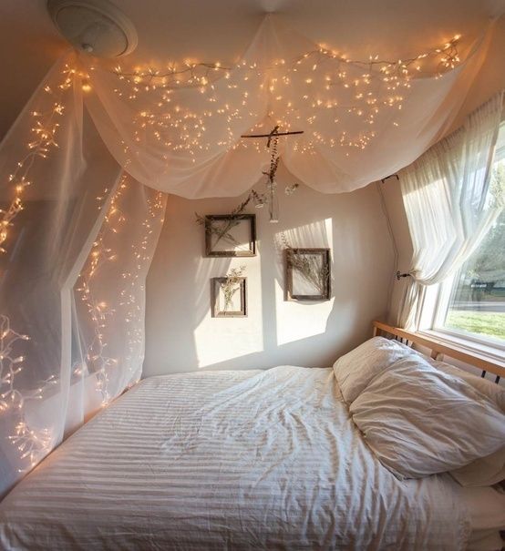 Fairy lights over bed curtains